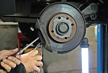 Closeup of mechanic changing brake pads