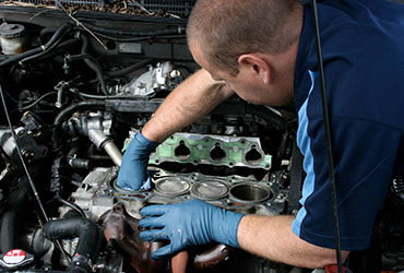 Closeup of mechanic working on car engine