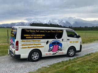 Noble Auto Services van with snow covered Alps in background